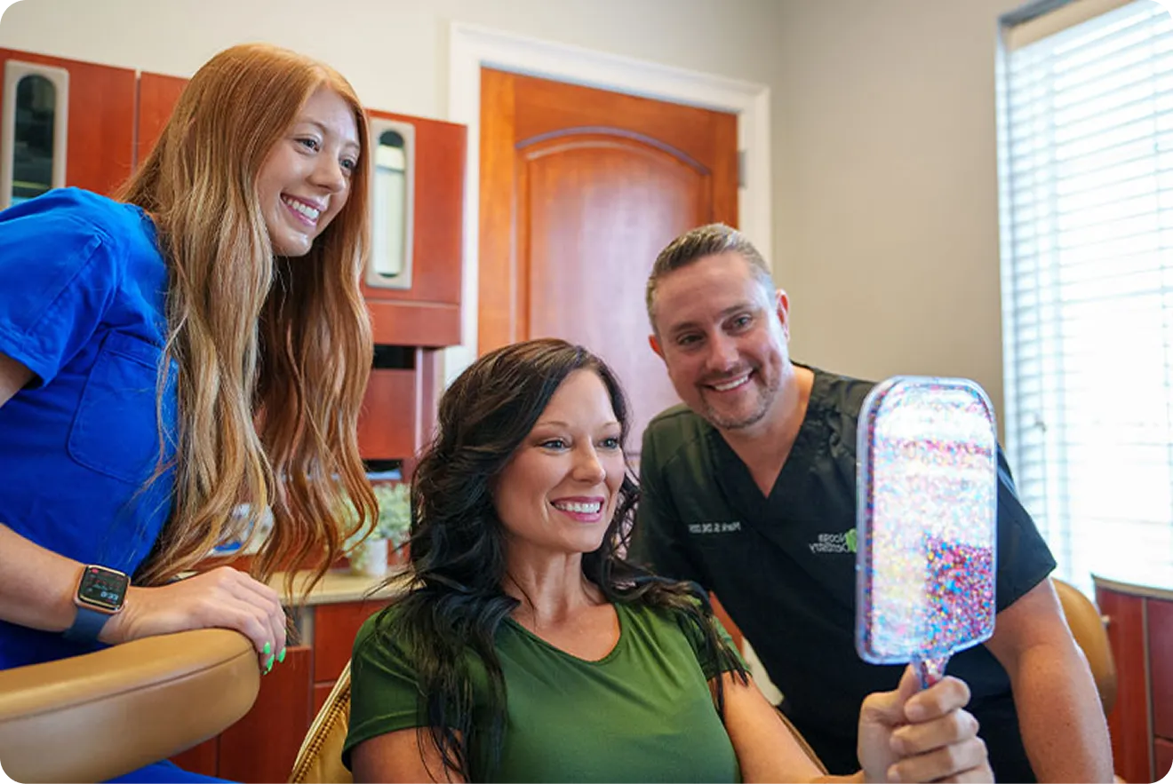 Patient showing their final dental implant results