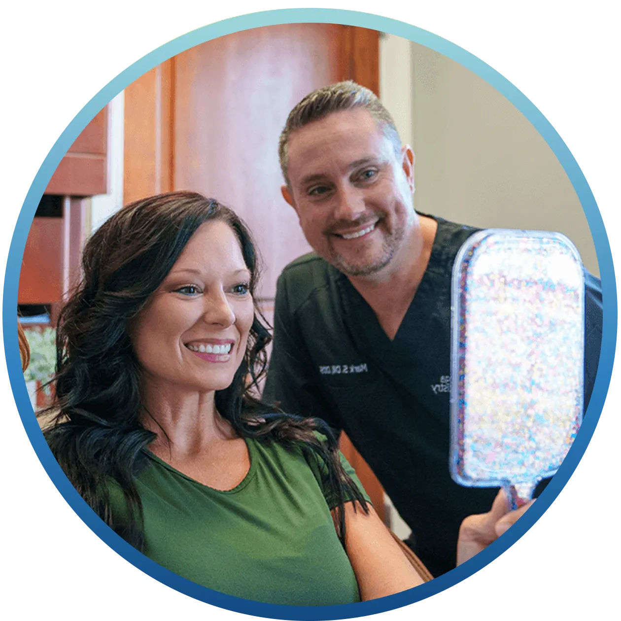 Dr. Dill and patient smiling after successful dental implant treatment