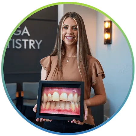 Nooga Dentistry team member holding a dental model
