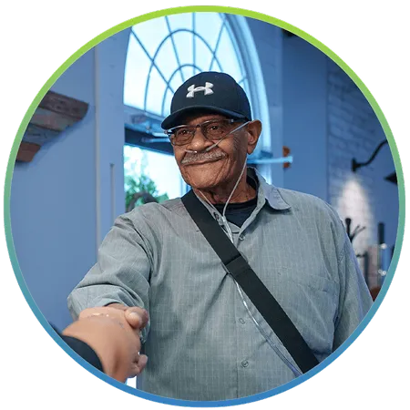 Joseph, full-arch dental implant patient, smiling in the Nooga Dentistry lobby