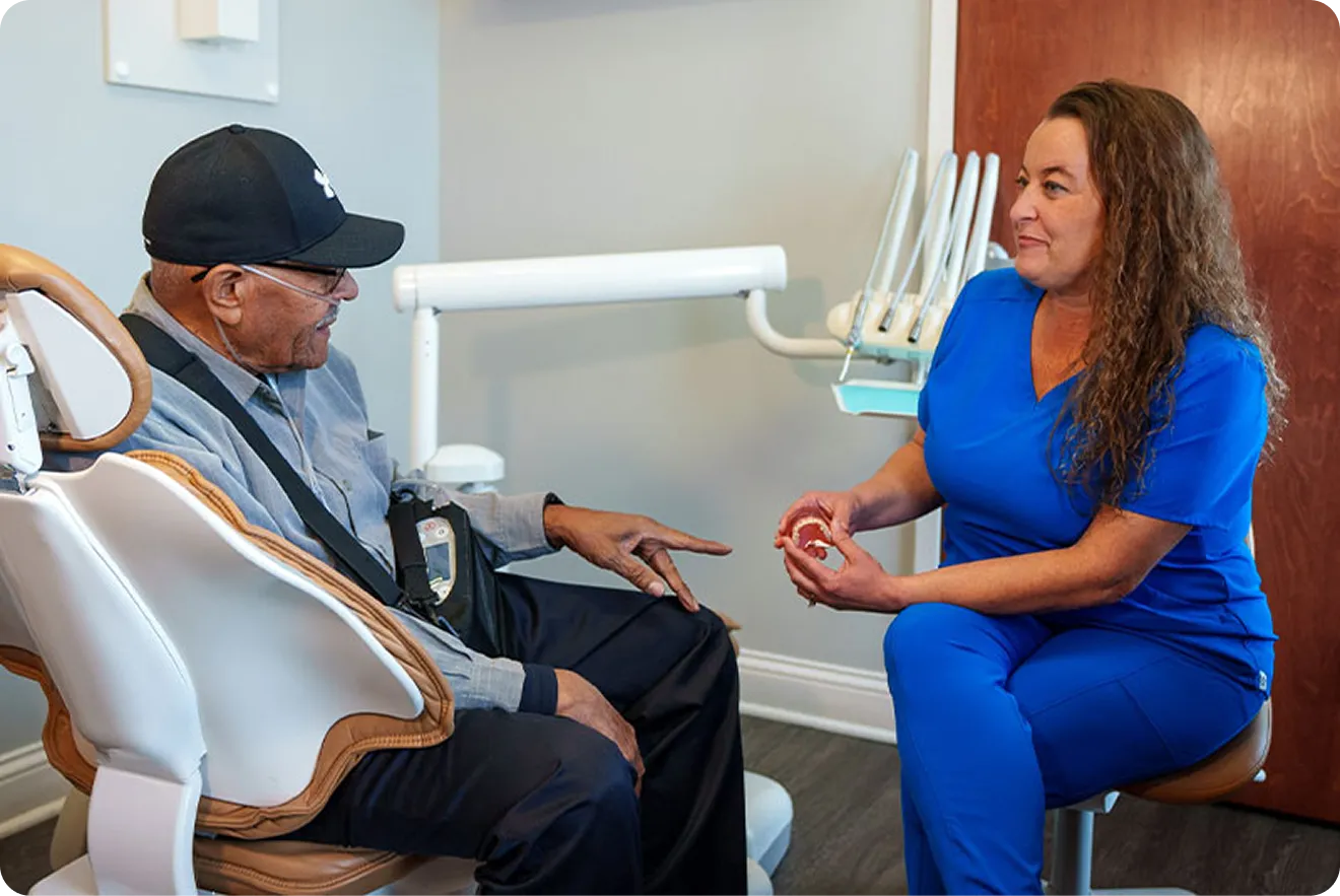 Dental professional consulting with a patient about implant surgery