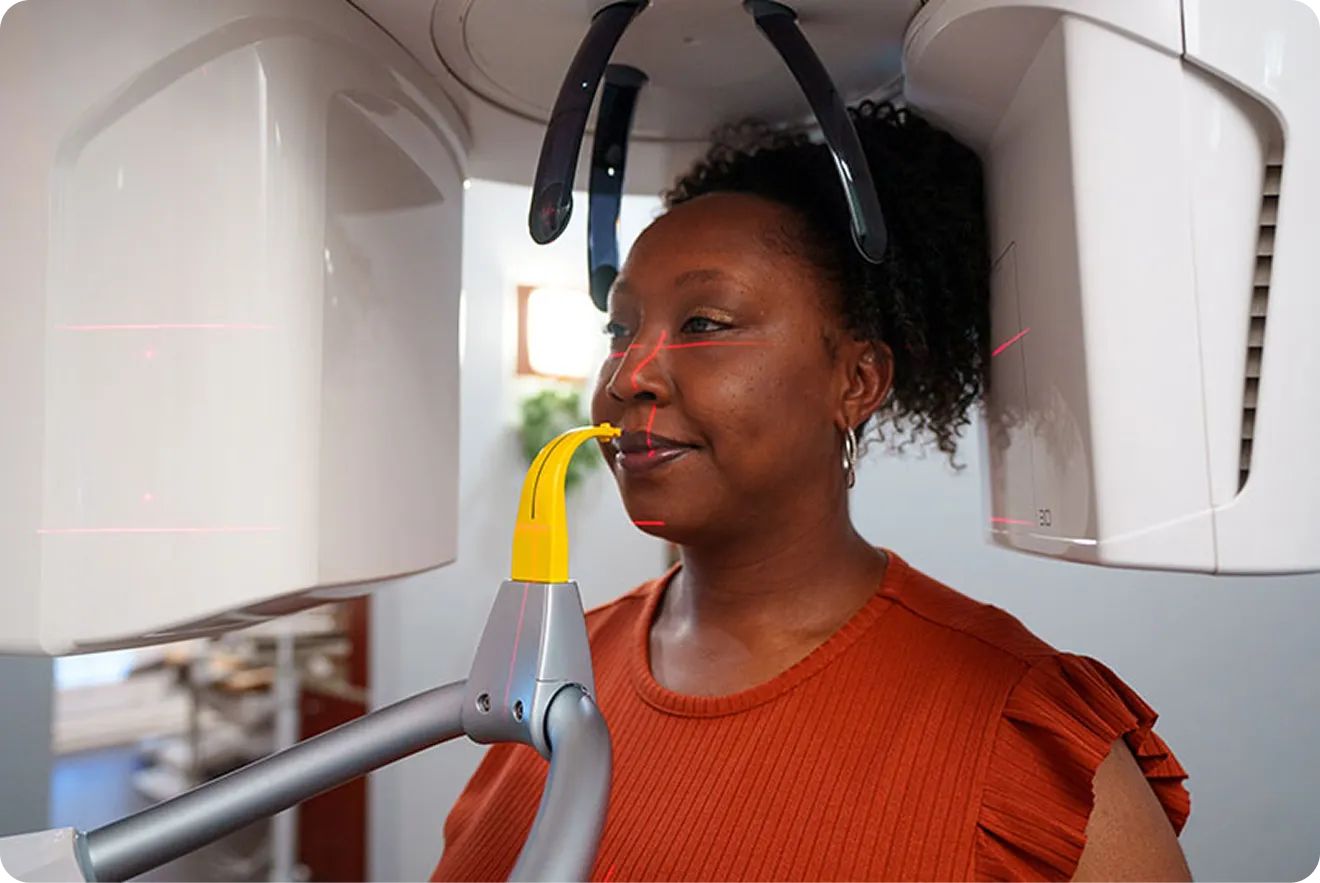 Patient receiving a dental scan during implant consultation