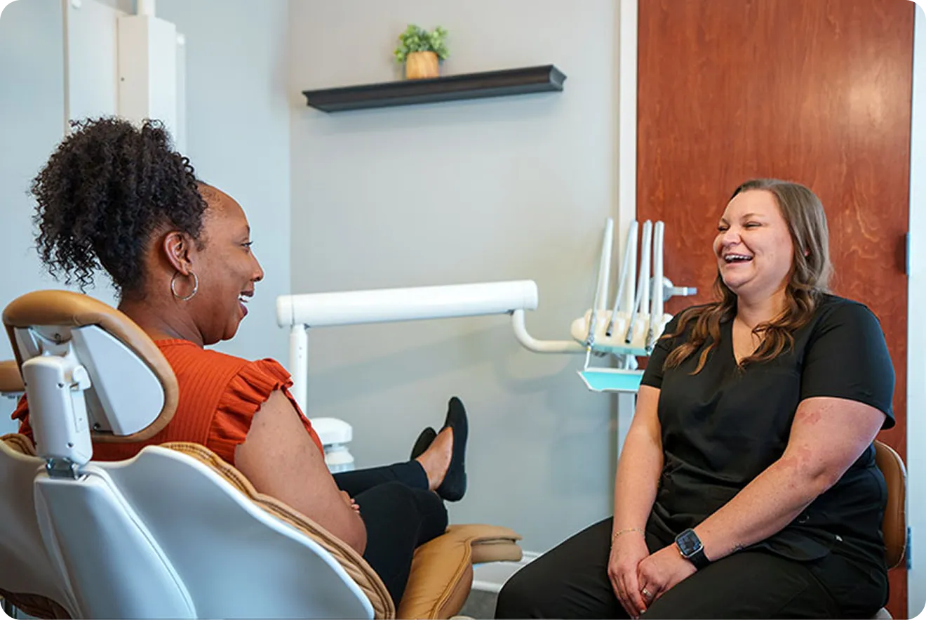 Patient smiling after full-mouth dental implant procedure